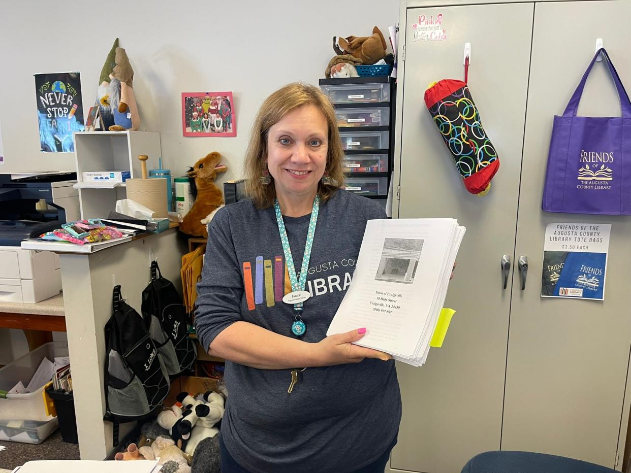 Craigsville Planning Commission President Janice Oakley with a loose-sheet proofreading copy of the Craigsville Community Cookbook.