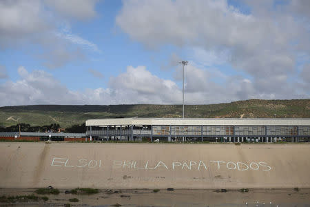 A view shows the San Ysidro Port of Entry, the border crossing between U.S. and Mexico, by the Tijuana river, in Tijuana, Mexico, February 22, 2017. The words read, "The sun shines for everyone". REUTERS/Edgard Garrido