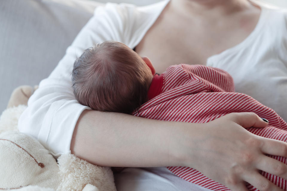 Mom breastfeeding a baby boy. Tongue-tie can contribute to nipple soreness or damage. (Getty Images)