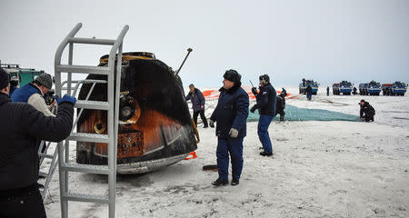 A Search and rescue team works at the landing site of the Soyuz MS-06 space capsule with International Space Station crew members Joe Acaba and Mark Vande Hei of the U.S., and Alexander Misurkin of Russia in a remote area outside the town of Dzhezkazgan (Zhezkazgan), Kazakhstan, on February 28, 2018. REUTERS/Alexander Nemenov/Pool