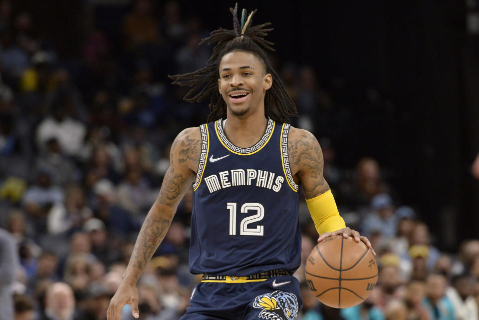 Memphis Grizzlies guard Ja Morant (12) brings the ball upcourt in the first half of an NBA basketball game against the Utah Jazz, Friday, Jan. 28, 2022, in Memphis, Tenn. (AP Photo/Brandon Dill)