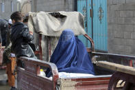 Afghans wait to receive food rations organized by the World Food Program (WFP) in Pul-e-Alam, the capital of Logar province. eastern of Afghanistan, Tuesday, Jan. 18, 2022. The Taliban's sweep to power in Afghanistan in August drove billions of dollars in international assistance out of the country and sent an already dirt-poor poor nation, ravaged by war, drought and floods, spiralling toward a humanitarian catastrophe. (AP Photo/Zubair Abassi)