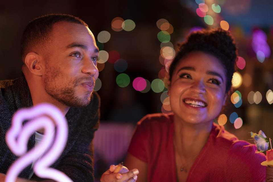 This image released by Freeform shows Kendrick Sampson, left, and Aisha Dee in a scene from "Ghosting: The Spirit of Christmas" airing December 4 on Freeform. (David Bukach/Freeform via AP)