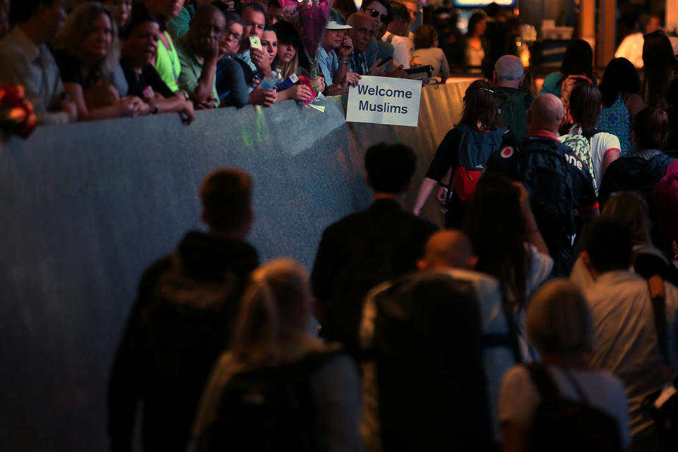 <p>Retired engineer John Wider, 59, holds up a sign reading “Welcome Muslims” as international travelers arrive at Los Angeles International Airport in Los Angeles, California, U.S., June 29, 2017. (Mike Blake/Reuters) </p>