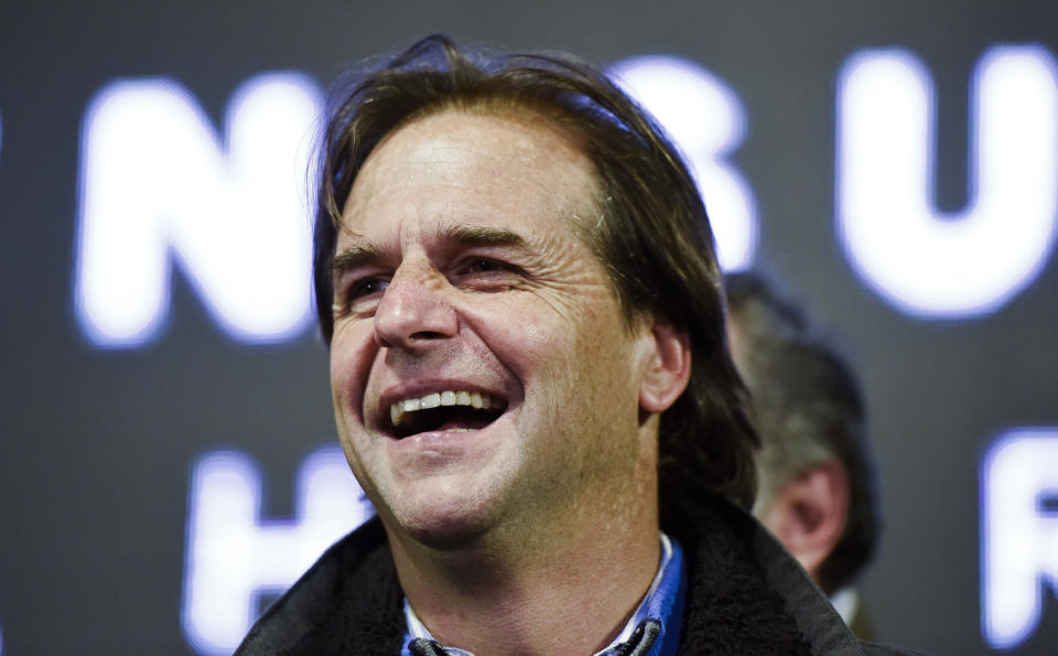 Presidential candidate Luis Lacalle Pou, leader of the opposition National Party, smiles before supporters during his campaign rally in San Jose, Uruguay, Tuesday, Oct. 22, 2019. Lacalle Pou, 47, is a longtime legislator with deep political roots, his father was president in the 1990s and his mother was a senator. He ran for president in 2014, losing to the current president in a runoff. (AP Photo/Matilde Campodonico)