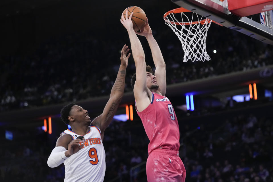 Washington Wizards forward Deni Avdija dunks past New York Knicks guard RJ Barrett during the second half of an NBA basketball game Wednesday, Jan. 18, 2023, at Madison Square Garden in New York. The Wizards won 116-105. (AP Photo/Mary Altaffer)