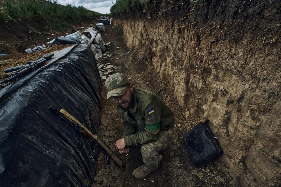A Ukrainian soldier sits in a trench at the frontline near Bakhmut (Copyright 2023 The Associated Press. All rights reserved.)