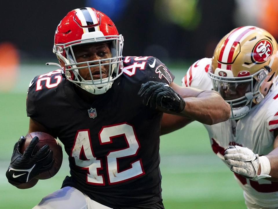 Caleb Huntley fights off a defender against the San Francisco 49ers.