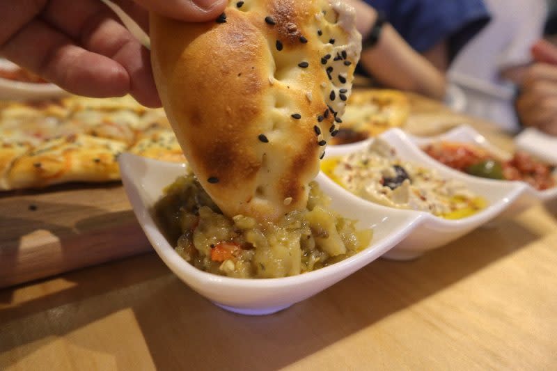 the Mediterranean deli turk - dipping of bread with baba ghanoush