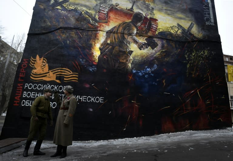 Men dressed in Red Army World War II uniforms take part in the opening of a street art-style painting promoting the new Russian film "The Panfilov 28" in Moscow