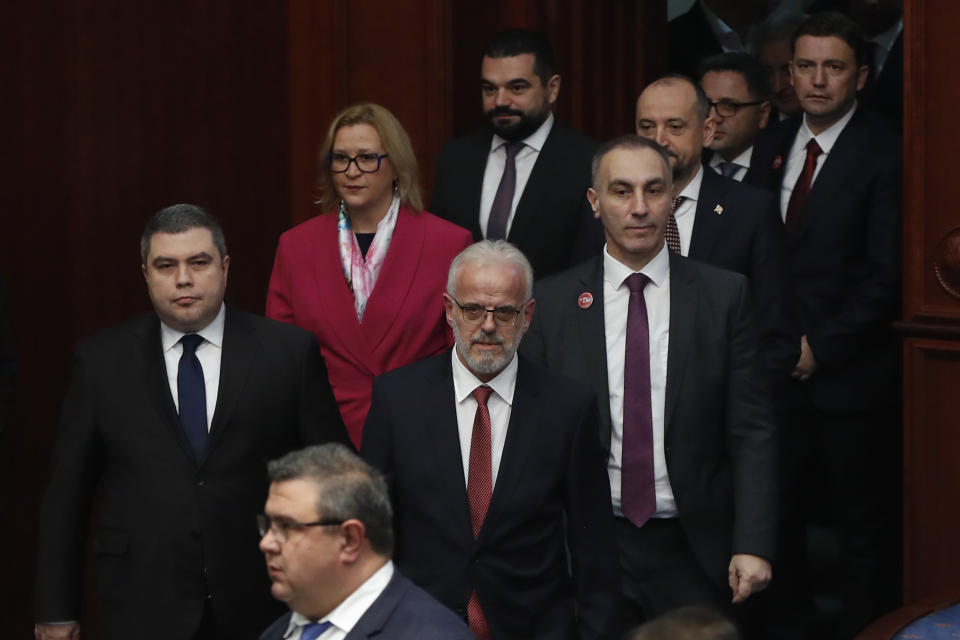 Talat Xhaferi, center, nominated to serve as prime minister of the caretaker government, arrives with his cabinet members to a session of the parliament in Skopje, North Macedonia, on Sunday, Jan. 28, 2024. North Macedonia's parliament has approved on Sunday a new caretaker government installed ahead of general elections this May. (AP Photo/Boris Grdanoski)