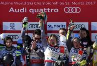 Alpine Skiing - FIS Alpine Skiing World Championships - Alpine Team Event - St. Moritz, Switzerland - 14/2/17 - Slovakia's Andreas Zampa (L) looks on as (2nd L to R) France's Mathieu Faivre, Adeline Baud Mugnier, Alexis Pinturault, Tessa Worley and Nastasia Noens celebrate winning gold during the flower ceremony following the final of the parallel slalom Mixed Team event. REUTERS/Denis Balibouse