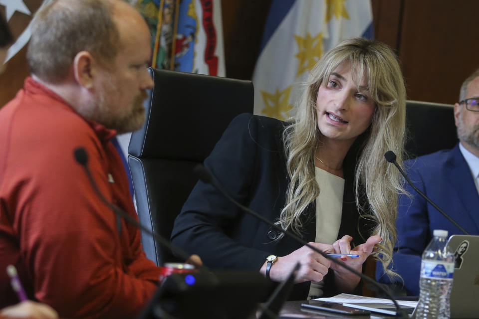 Transgender Mayoral candidate Rosemary Ketchum (right) speaks with City Council member Ben Seidler (left) during a City Council meeting On Friday, April 5, 2024, in Wheeling, W.Va. (AP Photo/Kathleen Batten)