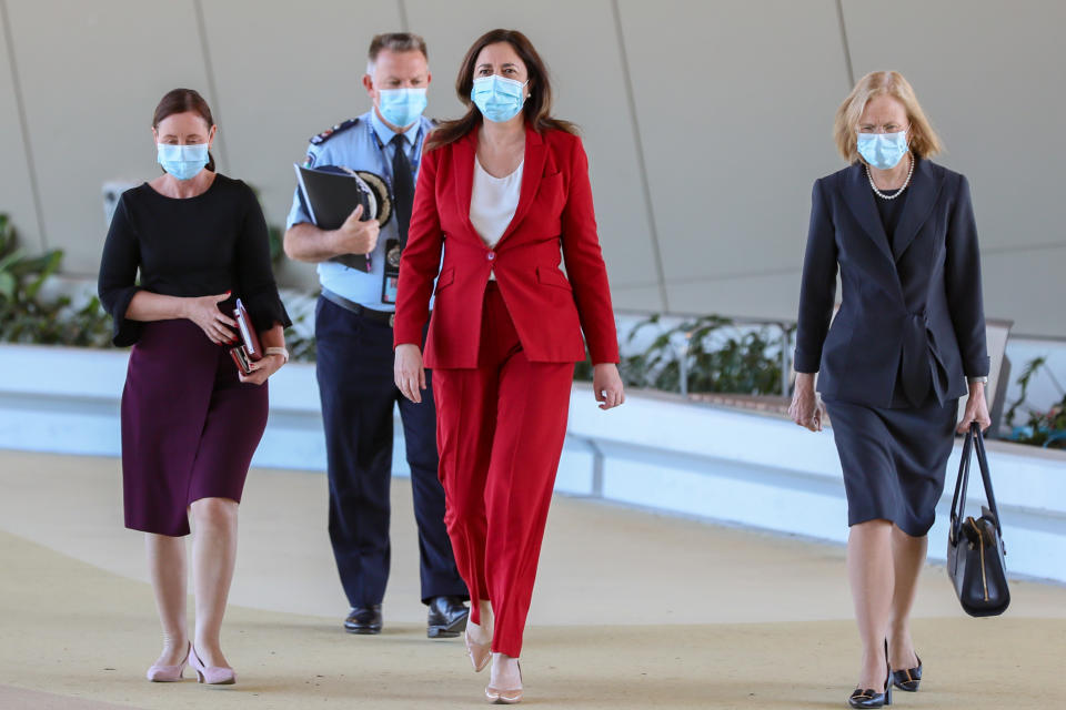 Queensland Police Acting Deputy Commissioner Shane Chelepy, Queensland Premier Annastacia Palaszczuk and Queensland Chief Health Officer Dr Jeannette Young arrive to a press conference. Source:AAP