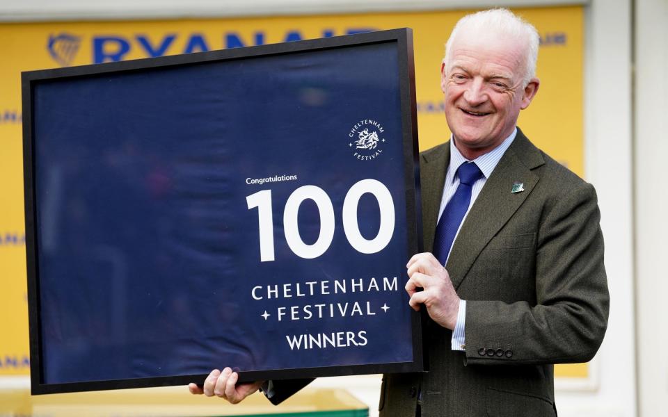 Trainer Willie Mullins is presented with a 100 Festival winners saddle cloth on day three of the 2024 Cheltenham Festival