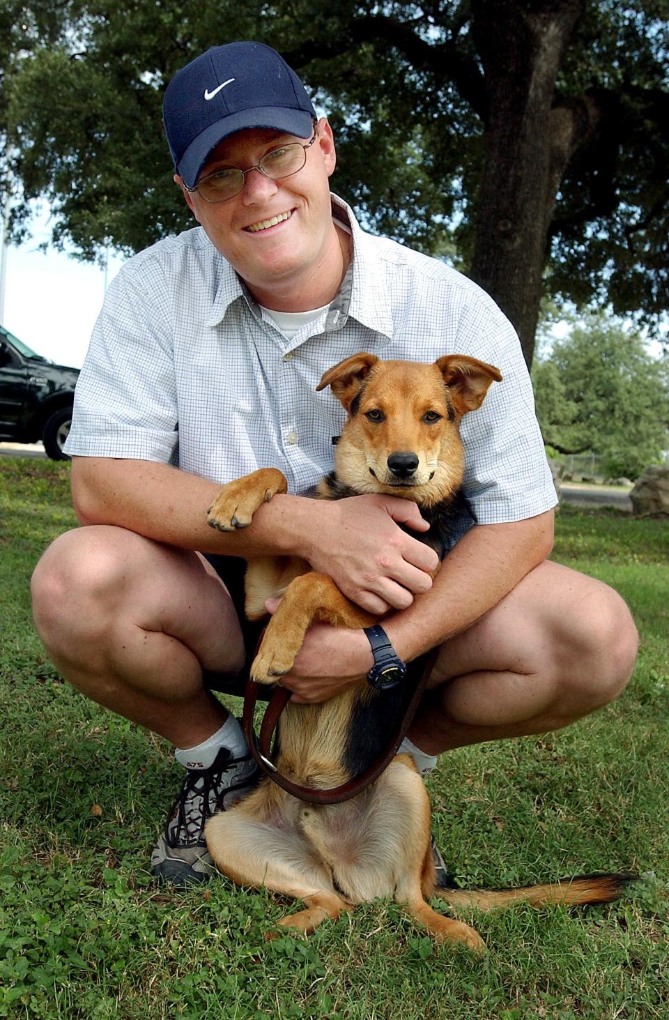 Phillip Paris is seen in this 2004 file photo when he was a Georgetown police officer and a dog trainer. He has been sued after a fire at his Georgetown kennel killed 75 dogs.