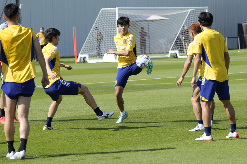 Players warm up during a training session of Japan national team in Doha, Qatar, Friday, Nov. 25, 2022. (AP Photo/Eugene Hoshiko)