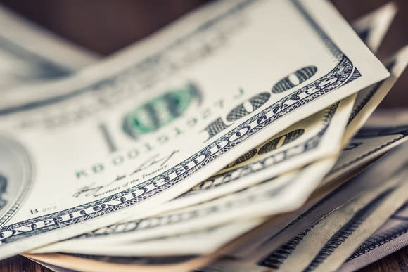 A close-up of a stack of $100 bills.