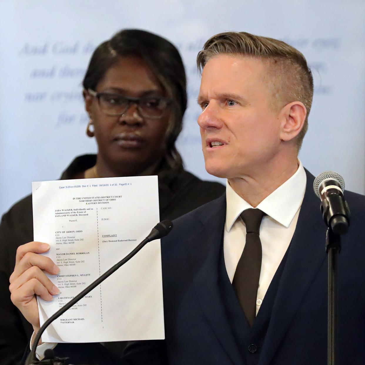 Bobby DiCello, the attorney representing Jayland Walker's family, holds up a copy of the $45 million lawsuit filed against the city of Akron, its police department and the eight officers who shot and killed Walker last summer during a news conference Friday at the First Congregational Church of Akron.