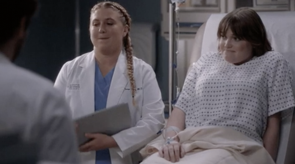 a doctor standing next to a patient in a robe