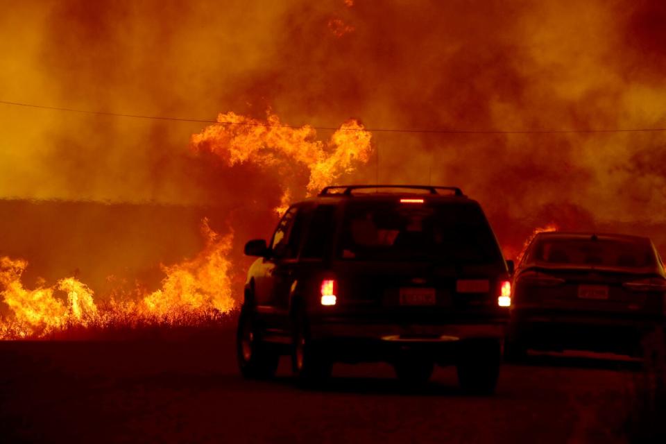 Motorists flee the Fairview fire as it burns long Batista Road