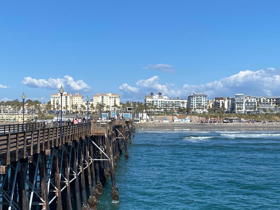 The picture-perfect blue Pacific Ocean rolls toward shore at the Oceanside Pier Surfing Area. The wide, sandy beaches offer incredible, consistent surf because of the south-facing shoreline. International surfing and other water sports events are held here.