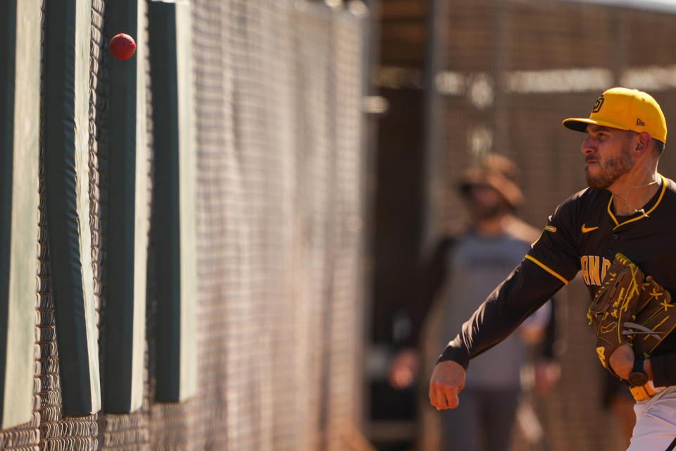 FILE - San Diego Padres starting pitcher Joe Musgrove throws a weighted ball against a pad to warm up during spring training baseball workouts Feb. 18, 2024, in Peoria, Ariz. Velocity training is the rage in baseball from the youth levels up through the majors. Players go through specialized programs – often using series of progressively weighted baseballs – in the hopes of speeding up their bodies and arms, pushing them to the limits of what might be possible for their age and ability. (AP Photo/Lindsey Wasson, File)