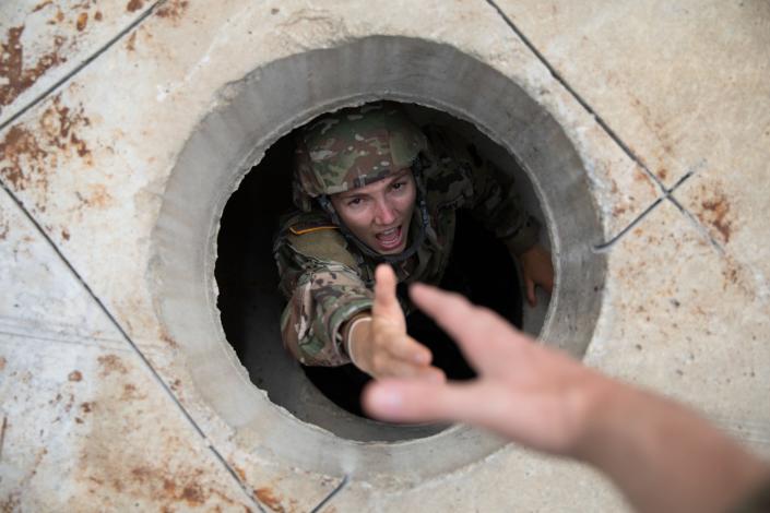 Army Reserve Sgt. Mikayla Fritz, a public affairs mass communication specialist with the 358th Public Affairs Detachment, reaches out for assistance at Muscatatuck Urban Training Center, Muscatatuck, Indiana, Aug. 16. (Spc. Addison Shinn/Army)