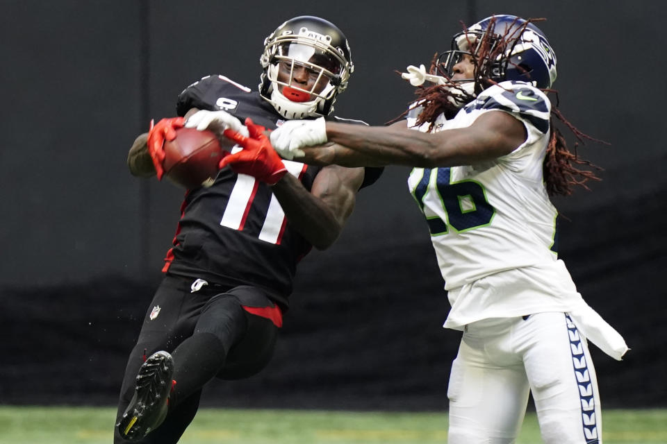 Atlanta Falcons wide receiver Julio Jones (11) makes the catch aganst Seattle Seahawks cornerback Shaquill Griffin (26) during the second half of an NFL football game, Sunday, Sept. 13, 2020, in Atlanta. (AP Photo/Brynn Anderson)