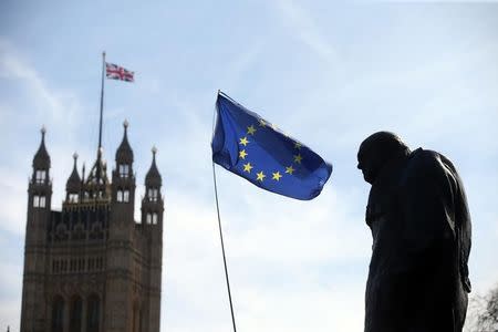 FILE PHOTO: An EU flag flies between the statue of Winston Churchill and a Union Flag flying from the Big Ben clock tower, during a Unite for Europe rally in Parliament Square, in central London, Britain March 25, 2017. REUTERS/Paul Hackett