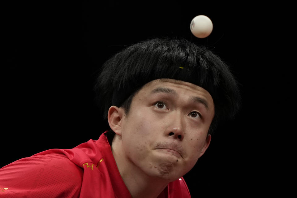 China's Wang Chuqin eyes the ball as he serves against his compatriot Fan Zhendong during their Table Tennis Men's Singles Final match for the 19th Asian Games in Hangzhou, Monday, Oct. 2, 2023. (AP Photo/Ng Han Guan)