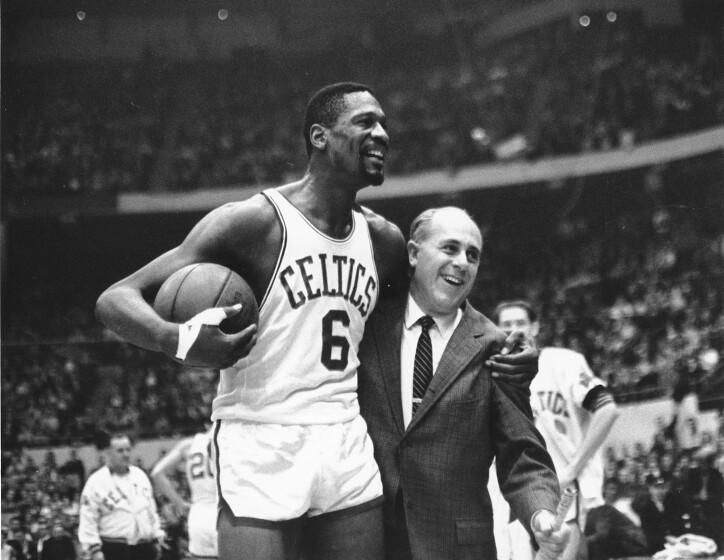** FILE **In this Dec. 12, 1964 file photo, Bill Russel, left, star of the Boston Celtics is congratulated.