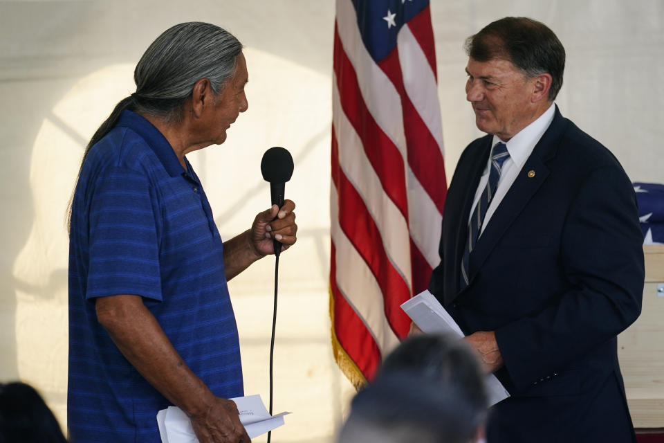 Russell Eagle Bear, a Rosebud Sioux tribal official, left, introduces Sen. Mike Rounds, R-S.D., during a ceremony at the U.S. Army's Carlisle Barracks, in Carlisle, Pa., Wednesday, July 14, 2021. The disinterred remains of nine Native American children who died more than a century ago while attending a government-run school in Pennsylvania were headed home to Rosebud Sioux tribal lands in South Dakota on Wednesday after a ceremony returning them to relatives. (AP Photo/Matt Rourke)