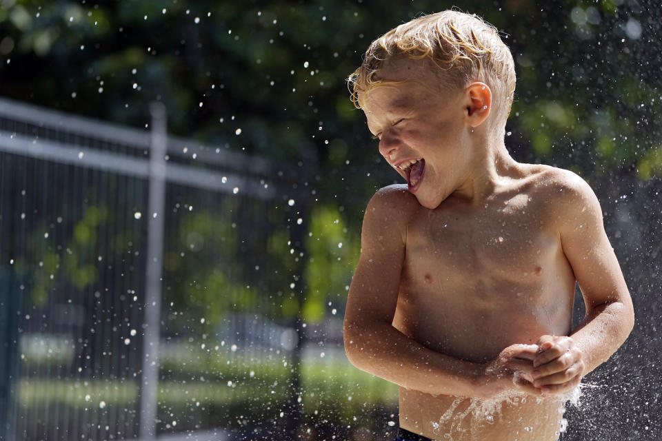 Cannon Brown, 5, plays in the water at a local park's splash pad Friday, June 30, 2023 in Nashville, Tenn. Weather forecasts call for heat indexes to reach over 105 degrees Fahrenheit for the Middle Tennessee area through the weekend. (AP Photo/George Walker IV)