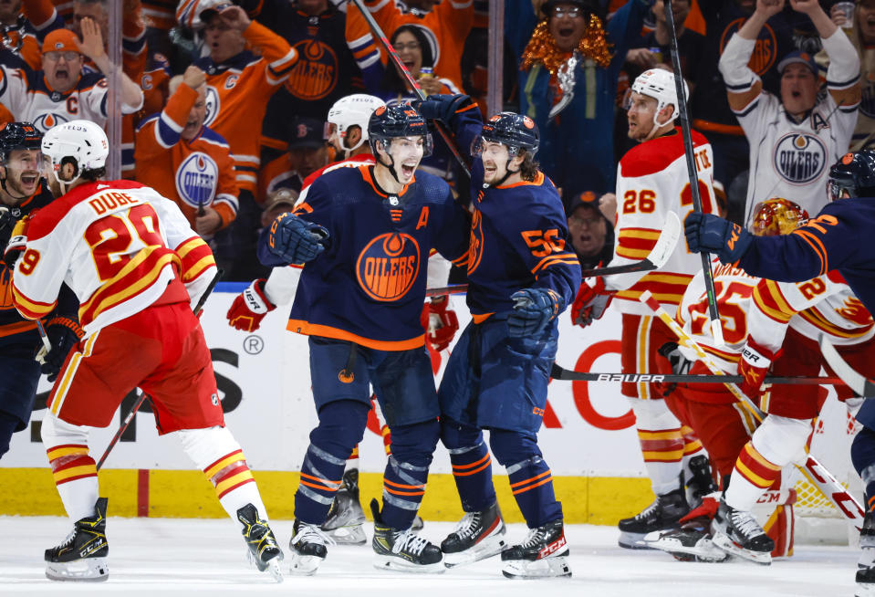 Edmonton Oilers center Ryan Nugent-Hopkins, center left, and teammates celebrate his goal against the Calgary Flames during the third period of Game 4 of an NHL hockey Stanley Cup playoffs second-round series Tuesday, May 24, 2022, in Edmonton, Alberta. (Jeff McIntosh/The Canadian Press via AP)