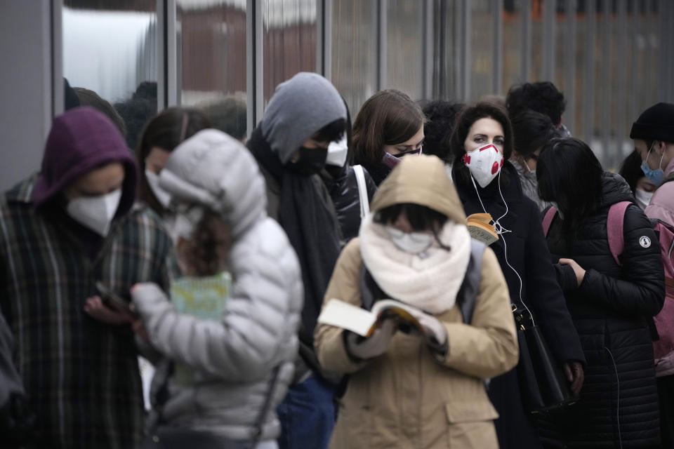 People queue up to get COVID-19 booster injections outside a vaccination centre in a UCL (University College London) building, in London, Friday, Dec. 17, 2021. After the U.K. recorded its highest number of confirmed new COVID-19 infections since the pandemic began, France announced Thursday that it would tighten entry rules for those coming from Britain. Hours later, the country set another record, with a further 88,376 confirmed COVID-19 cases reported Thursday, almost 10,000 more than the day before. (AP Photo/Matt Dunham)