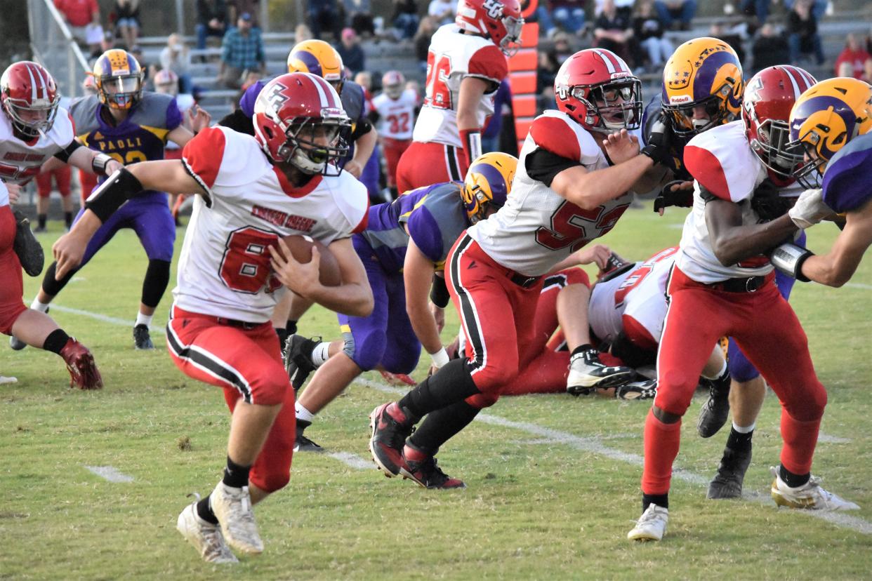 Eastern Greene's Jedd Cummings tries to find a seam while Ian Borst (53) and James Lewis IV block in their game against Paoli.