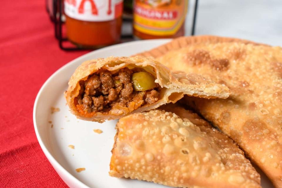 <p>Cook 2 Eat Well</p><p> These Cuban-style beef empanadas are filled with a flavorful picadillo.</p><p><strong>Get the recipe:</strong> <a href="https://www.cook2eatwell.com/empanadas/" rel="nofollow noopener" target="_blank" data-ylk="slk:Cuban Empanadas;elm:context_link;itc:0;sec:content-canvas" class="link ">Cuban Empanadas</a></p>