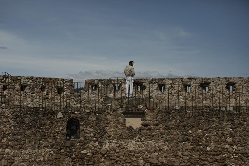 A man looks upon the city of Cannes from atop the Notre-Dame-d'Espérance church in Cannes, southern France, Tuesday, May 12, 2020. The Cannes Film Festival won't kick off as planned on Tuesday. The festival's 73rd edition has been postponed indefinitely, part of the worldwide shutdowns meant to stop the spread of the coronavirus. (AP Photo/Daniel Cole)