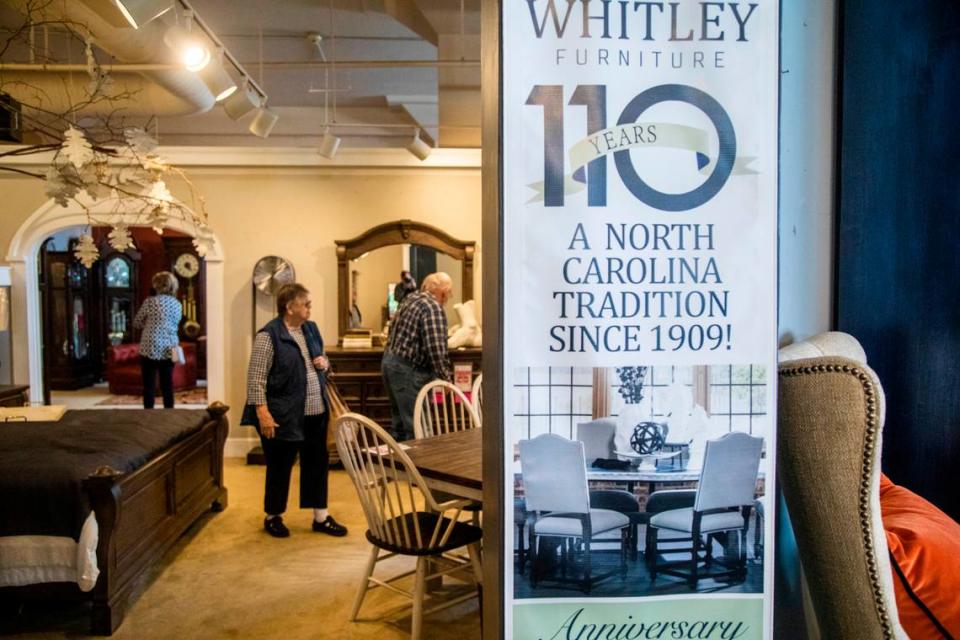 Customers shop at Whitley Furniture Gallery in downtown Zebulon Tuesday, Jan. 25, 2022. The store is going out of business after four generations of family operation and the city block it covers will likely be redeveloped.