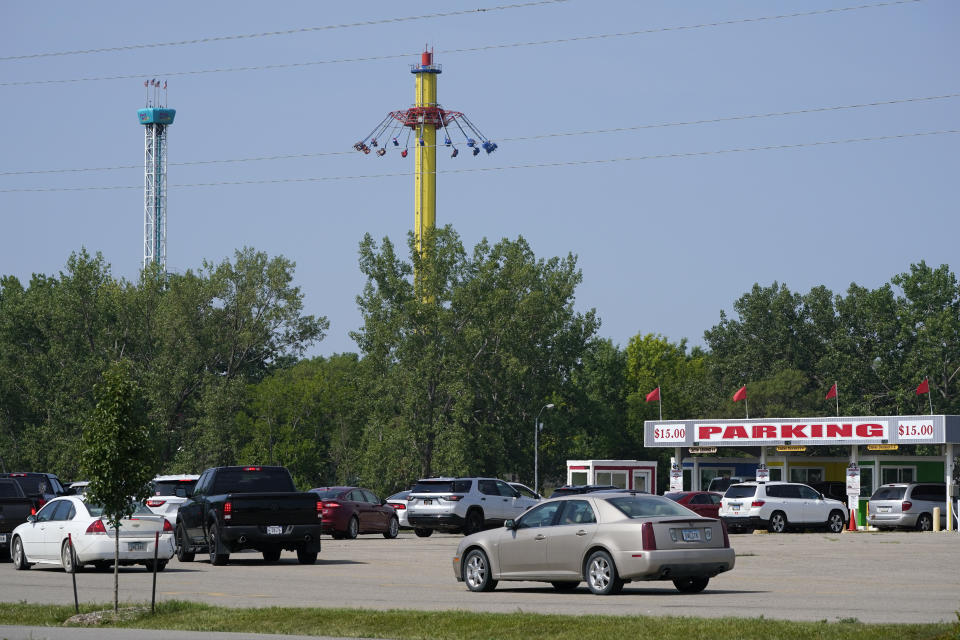 FILE - Visitors arrive at the Adventureland Park amusement park, July 6, 2021, in Altoona, Iowa. On Friday, Feb. 3, 2023, the managers of the Iowa amusement park said a ride that an 11-year-old boy died on in 2021 will never reopen. Adventureland's general manager announced the decision in a letter posted on the park's website. (AP Photo/Charlie Neibergall, File)