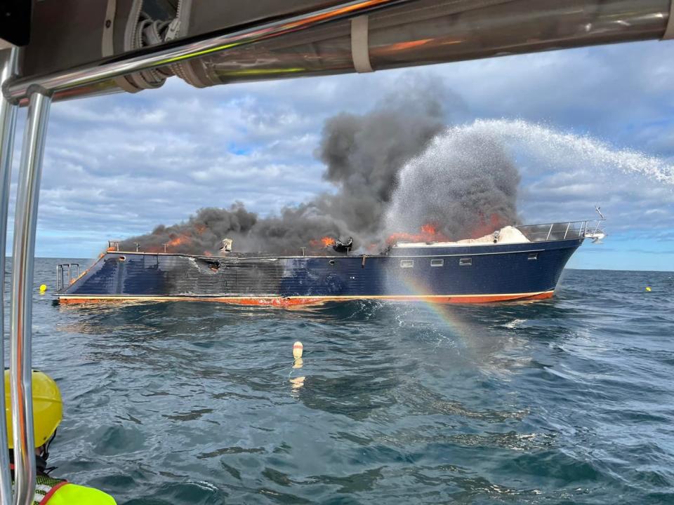 Portsmouth Fire Department members respond to a 70-foot Marlow yacht on fire off the coast of New Castle Saturday, June 18, 2022.