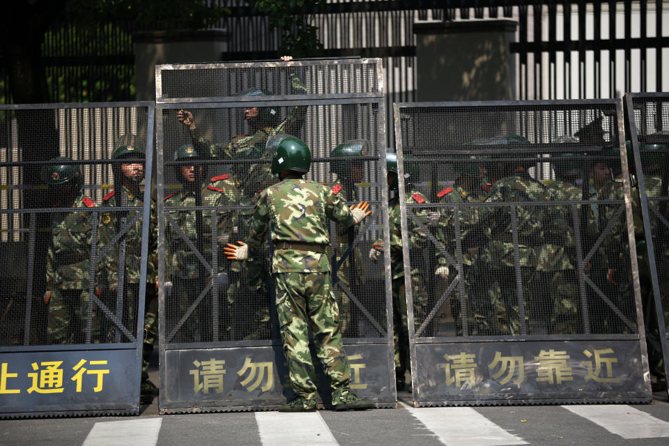 Paramilitary police officers arrange the steel fence at the Japanese Consulate General in Shanghai, China, Wednesday Sept. 19, 2012. China was returning to normalcy Wednesday after angry protests over Japan's wartime occupation and Tokyo's recent purchase of islands also claimed by Beijing. (AP Photo/Eugene Hoshiko)