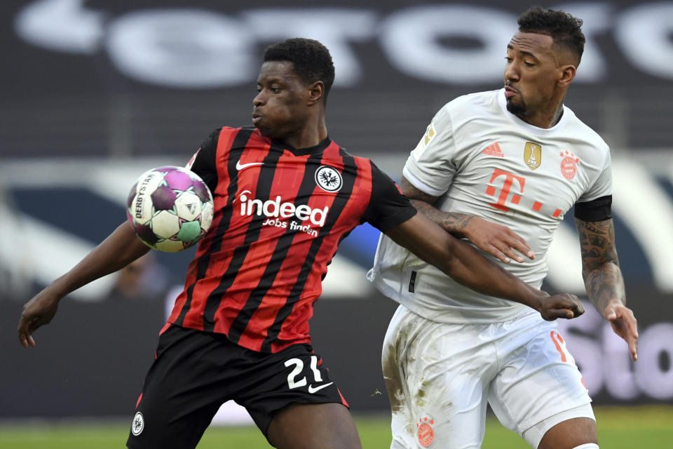 Frankfurt's Ragnar Ache, left, and Munich's Jerome Boateng, right, challenge for the ball during the German Bundesliga soccer match between Eintracht Frankfurt and Bayern Munich in Frankfurt, Germany, Saturday, Feb. 20, 2021. (Arne Dedert/POOL via AP)