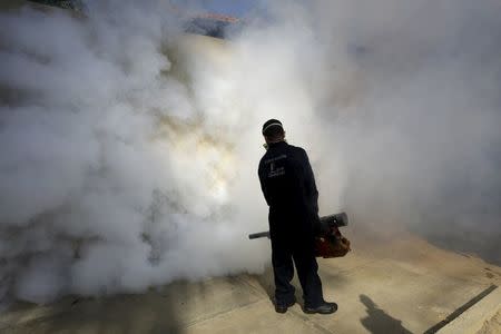 A municipal worker carries out fumigation to help control the spread of the mosquito-borne Zika virus in Caracas, Venezuela January 28, 2016. REUTERS/Marco Bellohttp://content.reuters.com/auth-server/content/