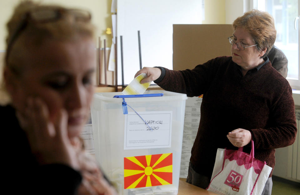 A woman cast her ballot for at a polling station in Skopje, Macedonia, Sunday, April 27, 2014. Macedonia votes Sunday in a presidential election runoff and snap parliamentary elections. (AP Photo/Boris Grdanoski)