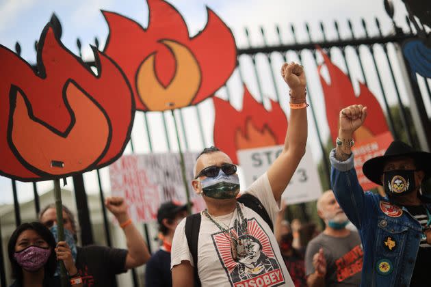 Demonstrators prepare to be arrested during a rally outside the White House as part of the 