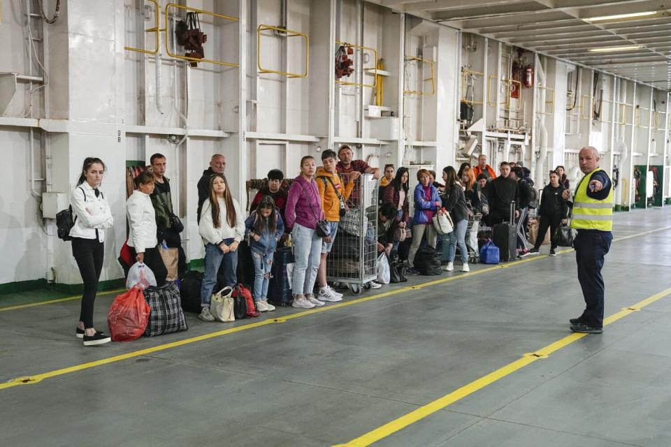 Ukrainian refugees line up on a ferry.