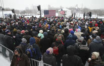 Snow falls as rally goers wait at Boom Island Park for the arrival of Democratic Sen. Amy Klobuchar and her announcement of her decision in the race for president at a rally Sunday, Feb. 10, 2019, at Boom Island Park in Minneapolis. (AP Photo/Jim Mone)