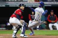 Kansas City Royals' Bobby Witt Jr. (7) scores past Cleveland Guardians catcher Bo Naylor on a sacrifice fly by Michael Massey during the sixth inning of a baseball game, Monday, Oct. 3, 2022, in Cleveland. (AP Photo/Ron Schwane)